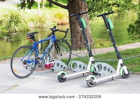 Christchurch, New Zealand - 1 December 2018: Lime Scooters Parked By A Bike At The Botanical Gardens