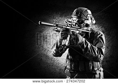 Fighter Of A Special Unit Is Aiming At The Sight Of The Machine Gun. Mixed Media