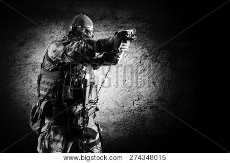 Fighter Of A Special Unit Is Aiming At The Sight Of The Machine Gun. Mixed Media