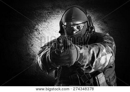 Fighter Of A Special Unit Is Aiming At The Sight Of The Machine Gun. Mixed Media