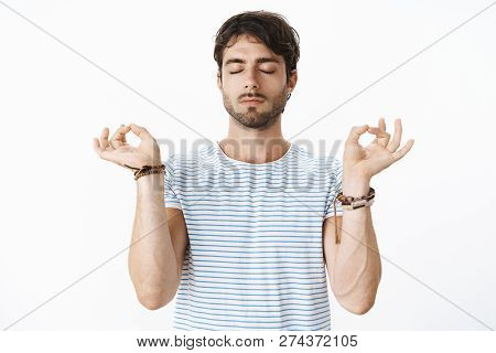Peace And Chill. Portrait Of Calm And Relaxed Focused Good-looking Male Yoga Teacher Standing In Lot
