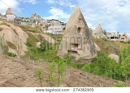 Residential Conical Caves In The Mountains Of Cappadocia Against The Backdrop Of Modern Architecture