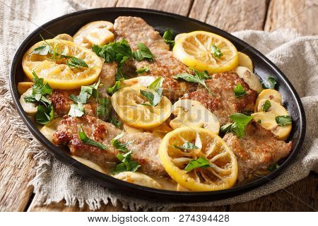 Italian Recipe Of Delicious Veal Scaloppini Cooked With Mushrooms And Lemons In A Spicy Sauce, Close