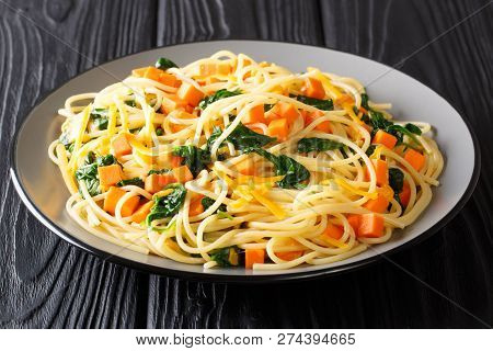 Simple Vegetarian Spaghetti Recipe With Pumpkin, Spinach And Cheese Closeup On A Plate. Horizontal