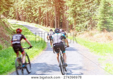 Ukraine, Vinnitsa, July 17, 2028. Cyclists Ride On Asphalt Road In The Forest, Cycling Competitions,