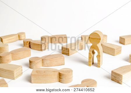 A Wooden Figure Of A Man With An Empty Child-shaped Inside The Body Is Standing Among Other People. 