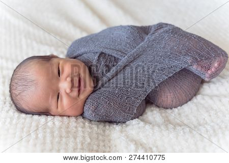 Smiling Asian Newborn Baby Boy In Mohair Wrap