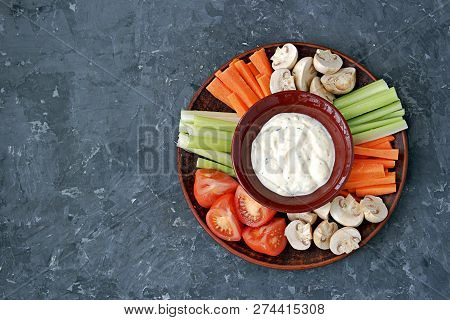 Vegetable Tray With A Ranch Dip On A Dark Background. Raw Vegetable Mix Includes Sliced Mushrooms, C