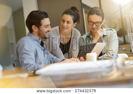 Colleagues workshopping business ideas in modern co working space