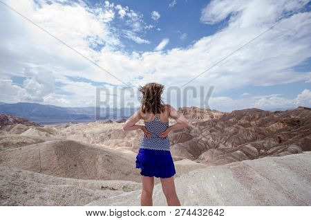 Adult Female With Back Facing The Camera At Zabriskie Point In Death Valley National Park, Californi