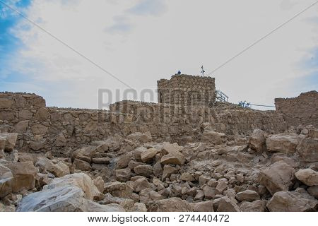 Ruins Of The Fortress Of Masada. On The Stone Walls There Is A Black Line That Delimits The Original
