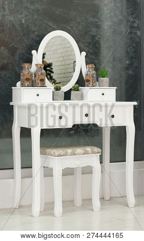 White Beauty Vintage Pier Glass With An Oval Mirror With A Chair Indoors