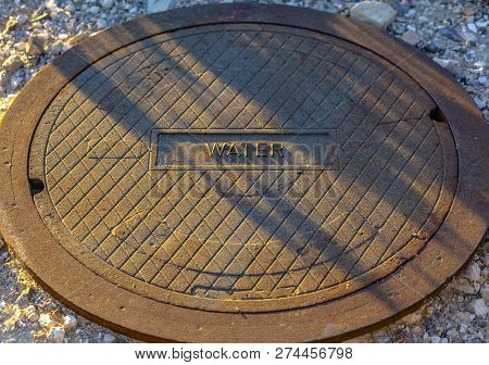 Man Hole Lid With Label Of Water On The Front
