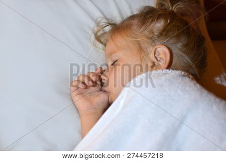 The Child Sucks Finger In Bed Before Bedtime And During Sleep