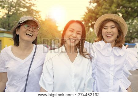 Three Asian Woman Relaxation Outdoor With Happiness Face