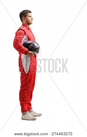 Full length profile shot of a male racer in a red jumpsuit standing and holding a halmet isolated on white background