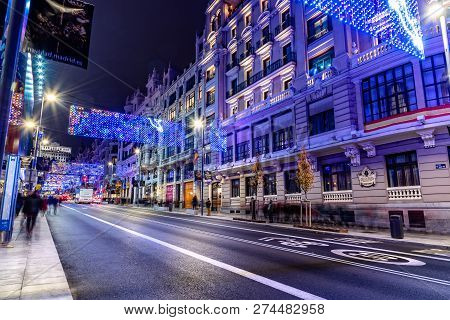 Madrid, Spain - December 15, 2018: Gran Via Avenue Illuminated At Christmas With Neon Lights And Tra
