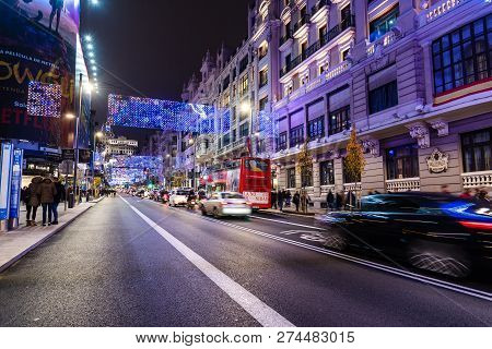 Madrid, Spain - December 15, 2018: Gran Via Avenue Illuminated At Christmas With Neon Lights And Tra