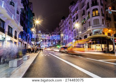 Madrid, Spain - December 15, 2018: Gran Via Avenue Illuminated At Christmas With Neon Lights And Tra
