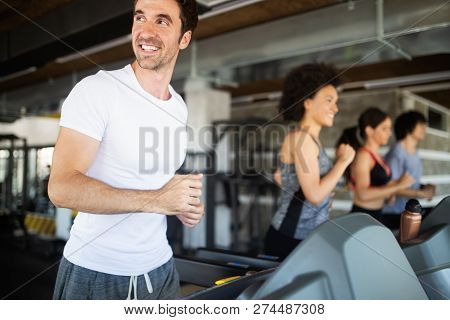 Happy Gorup Of Healthy People Training In Gym