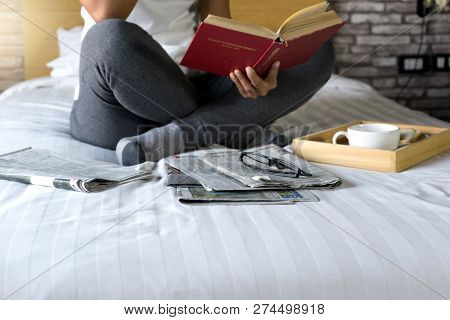 Relax Woman Read A Book On The Bed