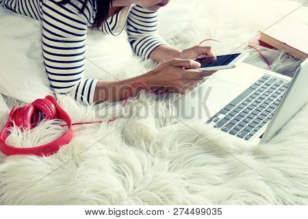 Girl Lying On The Bed Play Her Smartphone