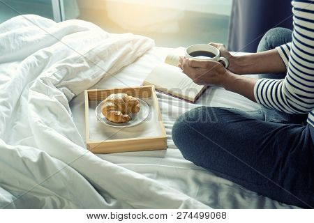 Relax Woman Read A Book On The Bed