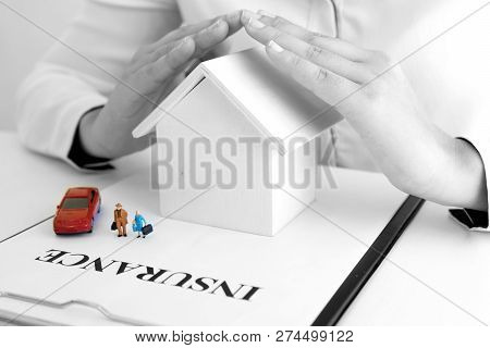 Young Woman Use Two Hand To Protect House