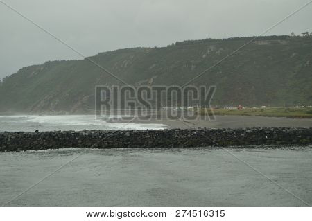 It Takes That We Can See A River Unraveling In The Sea And The Beach Of Los Quebrantos In A Rainy Da