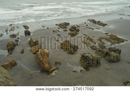 Remains Of Flysch Geological Formations On Los Quebrantos Beach On A Rain Day. July 30, 2015. Landsc