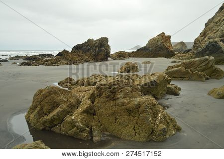 Remains Of Flysch Geological Formations On Los Quebrantos Beach On A Rain Day. July 30, 2015. Landsc