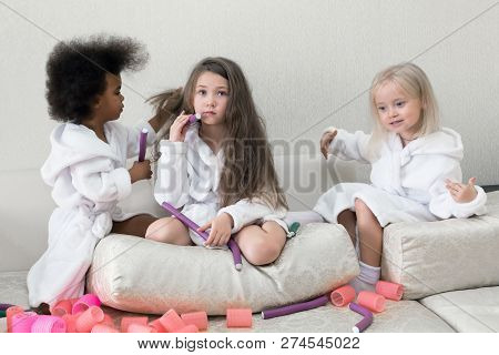 Little Girls Play With Hair Curlers And Hairpins.