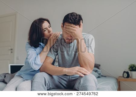Attractive Female Consoles Her Sad Boyfriend Who Has Depression And Some Problems, Pose At Bedroom O
