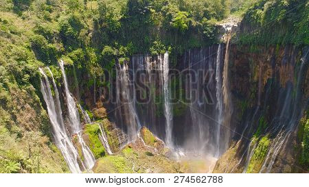 Beautiful Waterfall Coban Sewu In Tropical Forest, Java Indonesia. Aerial View Tumpak Sewu Waterfall