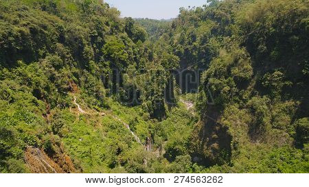 Aerial View Waterfall Coban Sewu In Java, Indonesia. Waterfall In Tropical Forest By Drone Tumpak Se