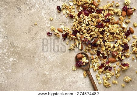 Homemade Multicereal Granola Scattered On A Slate Table.top View With Copy Space.