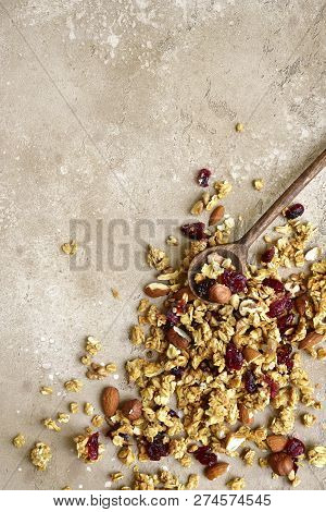 Homemade Multicereal Granola Scattered On A Slate Table.top View With Copy Space.