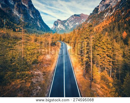 Aerial View Of The Road In Mountain Forest At Sunset In Dolomites. Top View Of Perfect Asphalt Roadw
