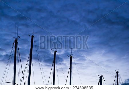Masters Boat Mast Silhouetted Against The Cloudy Sky