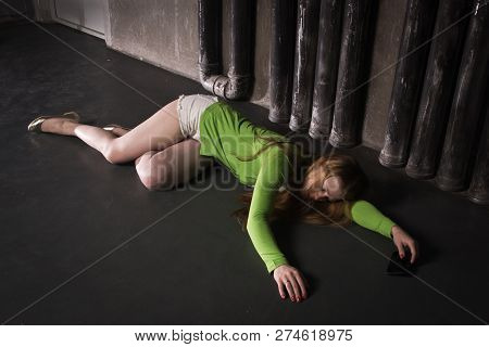 Lifeless Unconscious Woman Lying On A Factory Floor