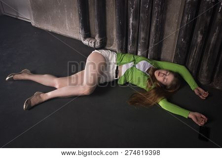Lifeless Unconscious Woman Lying On A Factory Floor