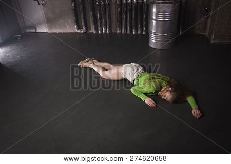 Lifeless Unconscious Woman Lying On A Factory Floor