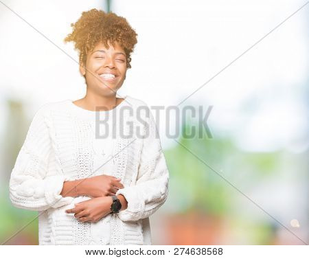 Beautiful young african american woman wearing winter sweater over isolated background Smiling and laughing hard out loud because funny crazy joke. Happy expression.