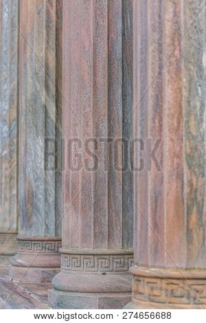 Row Of Towering Columns Outside A Building