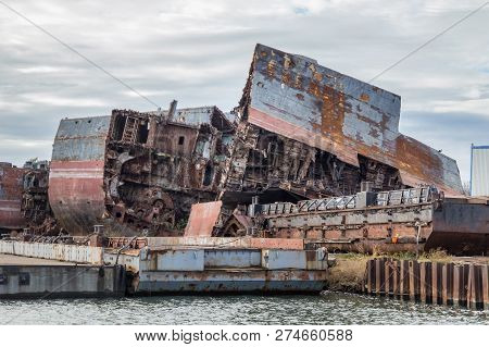 Huge Rusty Pieces Of Decommissioned Marine Ship That Was Cut And Left On The Shore.