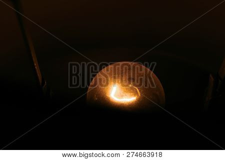 A Dusty, Vintage-style Light Bulb Barely Lit