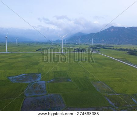 Wind Turbine Farm Or Windmill On Blue Sky. Turbine Green Energy Electricity Or Wind Turbine In A Gre