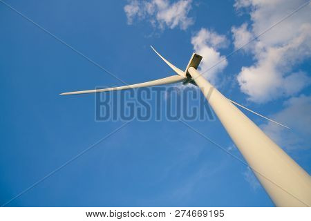 View Up, Bottom View Of Wind Turbine, Windmill Isolated On Blue Sky Background. Royalty High-quality