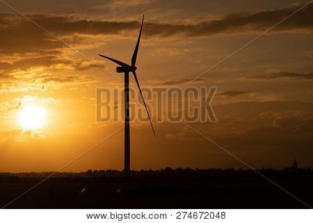 Wind Turbines Farm And Agricultural Fields On Blue Sky. Turbine Green Energy Electricity Or Wind Tur