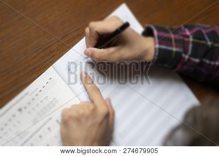 Close Up Student Hands Write Down Music Notes On Class In School